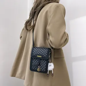 Vertical grey geometric crossbody phone bag featuring a cute white plush doll pendant detail