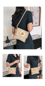Detail of straw crossbody bag featuring woven texture and white daisy flower decoration