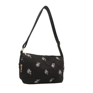 Minimalist black floral tote bag with white rose patterns and adjustable shoulder strap