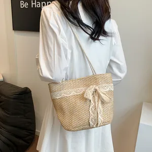Detalle del bolso de paja tejido a mano con encaje delicado y diseño de lazo dulce
