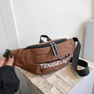 Close-up of brown waterproof nylon chest bag featuring adjustable strap and logo detail