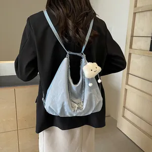 Light blue pleated crescent tote bag with silver butterfly chain and cloud charm
