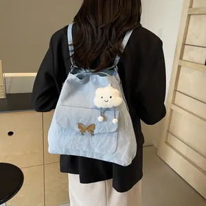 Pale blue tote bag with butterfly clasp and cloud charm shown on a female model