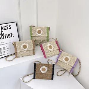 Straw woven crossbody bags with daisy accents in green brown pink purple and black