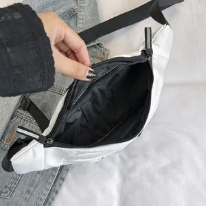 White waterproof nylon sports chest bag with black adjustable strap and zippers