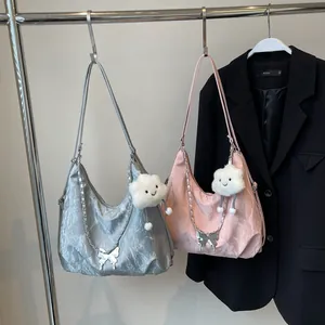 Detail of crinkled texture fabric on silver and pink tote bags with plush cloud charms