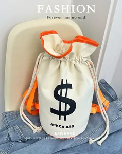 Detail of canvas bucket bag with orange straps, drawstring closure, and dollar sign print