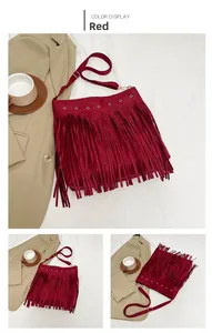 Detail view of burgundy tassel shoulder bag with metallic eyelets and suede texture finish