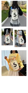 Detail of canvas drawstring bucket bag featuring a black dollar sign print and strap accents