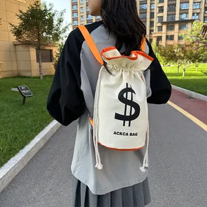 Detail of canvas drawstring bucket bag with orange straps and black dollar sign print