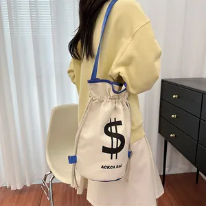 Detail view of canvas bucket bag featuring contrast blue trim and thick rope drawstring