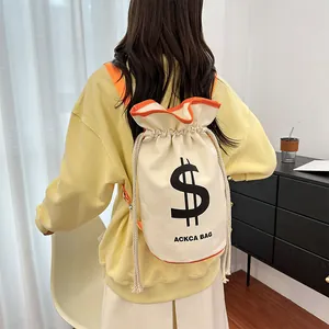 Detail of canvas drawstring bucket bag featuring a black dollar sign and orange trim detail