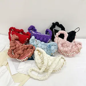 Quilted cloud bag detail showing various colors with pearl chain and scrunchie handle