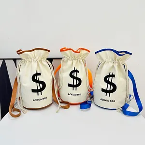 Three minimalist canvas bucket bags with colored straps and dollar sign print