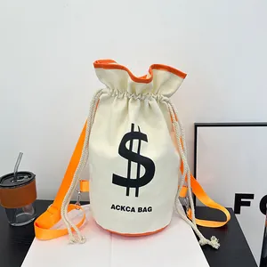 Detail of canvas bucket bag showing drawstring closure and bright orange trim accents