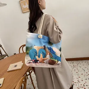 Detail of canvas tote bag with beach theme prints and decorative rope handles