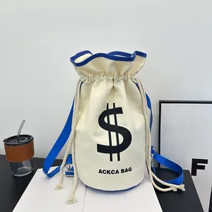 Detailed close-up of canvas bucket bag with drawstring closure and blue nylon strap
