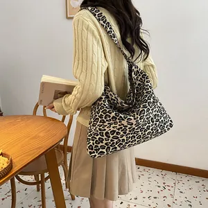 Close-up of the large leopard print tote bag with soft fabric texture and wide shoulder strap