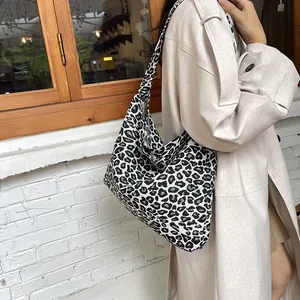 Detail of a large leopard print canvas tote bag featuring black and white animal patterns