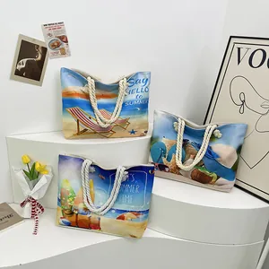 Detailed view of canvas beach tote bags with summer prints and white rope handles