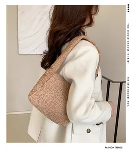 Close-up of fluffy camel faux fur shoulder bag worn by model for autumn winter style