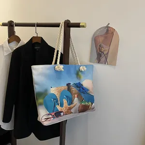 Detail of the large canvas tote bag with cotton rope handles and beach print on the body