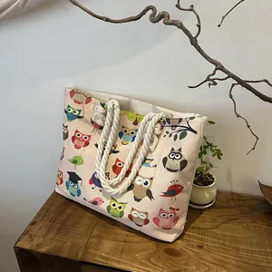 Detailed shot of canvas tote bag with colorful owl prints and cotton rope handles