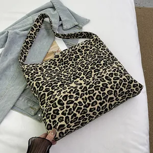 Detailed view of leopard print canvas tote bag with textured jacquard and wide shoulder strap