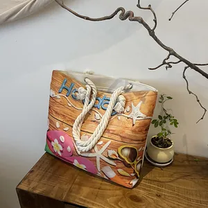 Close-up of canvas beach tote bag with hemp rope handles and summer holiday pattern