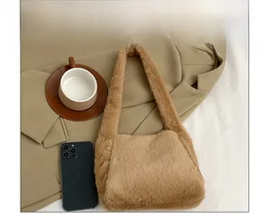 Detailed plush texture of light brown faux fur shoulder bag with wide strap design
