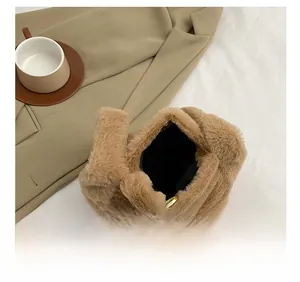 Detail show of fuzzy plush tote bag featuring black lining and gold magnetic closure