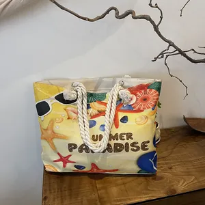 Detail of canvas tote bag with nautical prints, woven rope handles and Summer Paradise text