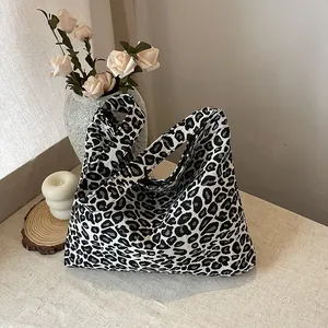 Detailed texture of leopard print tote bag with thick canvas fabric and wide strap