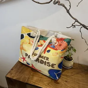 Detail of yellow canvas tote bag with Summer Paradise beach prints and rope handles
