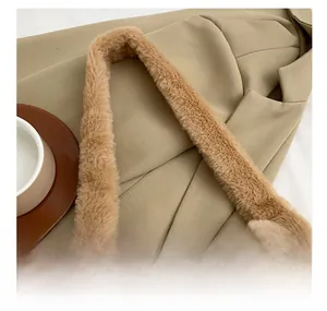 Close-up of the wide plush shoulder strap on a brown faux fur underarm bag
