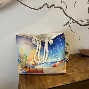 Detail of canvas beach tote featuring thick rope handles and 'It's Summer Time' print