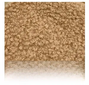 Macro detail of high-quality brown teddy fleece fabric with soft curly wool texture