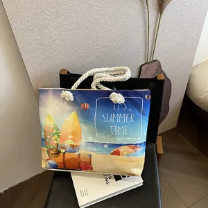 Detail of canvas tote bag with thick rope handles and summer beach theme print