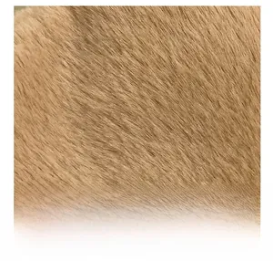 Detailed macro shot of soft light brown faux fur material with smooth plush texture