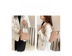 Furry lamb wool handbag in khaki showing both handheld and shoulder bag carrying styles