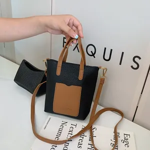 Détails de la texture du cuir PU noir et de la garniture dorée sur le sac à bandoulière