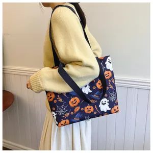 Lifestyle shot of a Halloween print tote bag with pumpkin icons on a shoulder model
