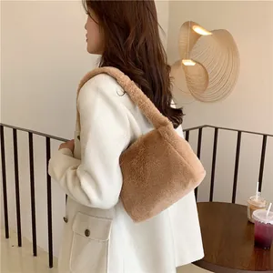 Detail view of brown faux fur hobo bag showing soft texture and wide plush shoulder strap