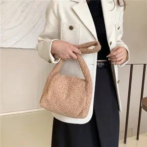 Plush faux fur tote bag in camel beige shown with a stylish autumn winter outfit