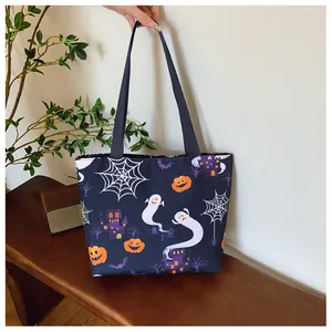Detail of Halloween tote bag featuring ghosts and pumpkins print with durable black handles