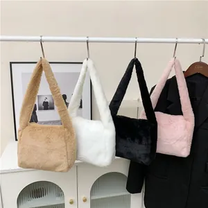 Furry plush shoulder bags in khaki, white, black, and pink displayed on a minimalist rack
