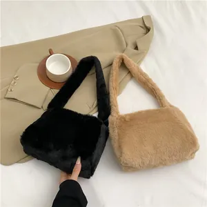 Detail of plush faux fur shoulder bags in black and beige khaki with wide strap