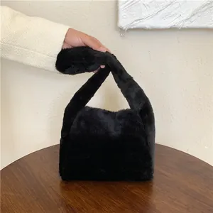 Close-up of fluffy black faux fur tote bag showing plush texture and wide handle