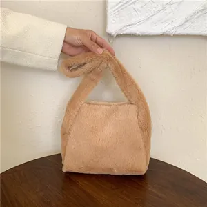 Close-up of soft faux fur texture and handle on this stylish brown plush shoulder bag