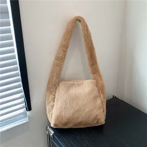 Close-up of the soft plush fabric texture on a light brown faux fur shoulder bag